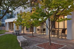 a park with benches and trees in front of a building at Courtyard by Marriott Mississauga-Airport Corporate Centre West in Mississauga