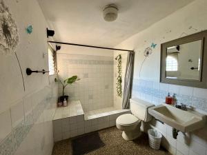 a bathroom with a toilet and a sink at NoMAD House in Guatemala