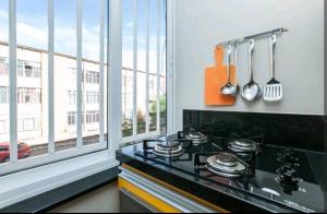 a kitchen with a stove top oven next to a window at Boa Opção Asa Sul in Brasilia