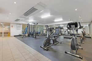 a gym with several treadmills and cardio machines at Comfy Studio Next to Chatswood Station in Sydney