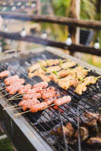 a bunch of sausages and other food on a grill at An Nhien Farm - Venuestay in Buon Ma Thuot