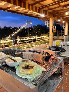 a grill with some food on top of it at An Nhien Farm - Venuestay in Buon Ma Thuot