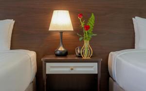 Postel nebo postele na pokoji v ubytování BIDV Central Da Lat Hotel