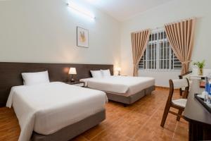 Postel nebo postele na pokoji v ubytování BIDV Central Da Lat Hotel