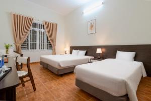 Postel nebo postele na pokoji v ubytování BIDV Central Da Lat Hotel