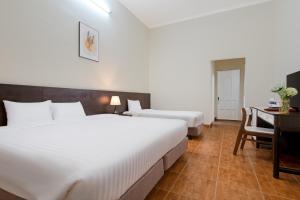 Postel nebo postele na pokoji v ubytování BIDV Central Da Lat Hotel