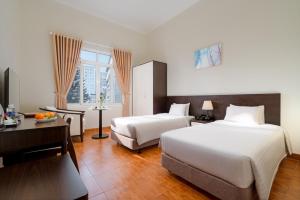 Postel nebo postele na pokoji v ubytování BIDV Central Da Lat Hotel