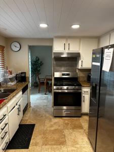 a kitchen with a stainless steel stove and refrigerator at Buxton Private Room and Bath Wheel Chair Access in Rialto