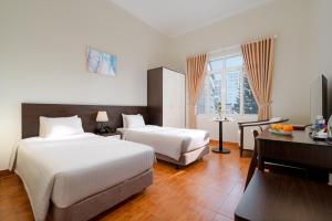 Postel nebo postele na pokoji v ubytování BIDV Central Da Lat Hotel