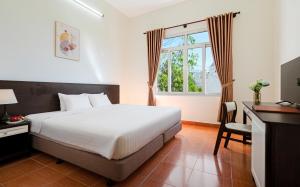 Postel nebo postele na pokoji v ubytování BIDV Central Da Lat Hotel