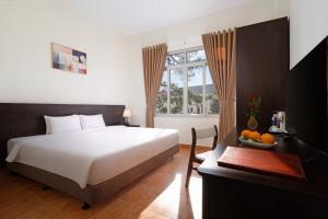 Postel nebo postele na pokoji v ubytování BIDV Central Da Lat Hotel + 31 fotografií