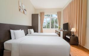 Postel nebo postele na pokoji v ubytování BIDV Central Da Lat Hotel