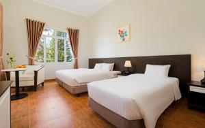 Postel nebo postele na pokoji v ubytování BIDV Central Da Lat Hotel