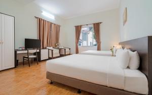 Postel nebo postele na pokoji v ubytování BIDV Central Da Lat Hotel
