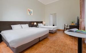 Postel nebo postele na pokoji v ubytování BIDV Central Da Lat Hotel