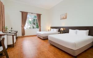 Postel nebo postele na pokoji v ubytování BIDV Central Da Lat Hotel