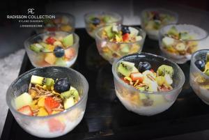 a group of bowls of fruit salad on a table at Radisson Collection Hyland Shanghai in Shanghai