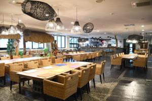 a restaurant with tables and chairs and pendant lights at Ita taiwan indigenous cultural resort in Taitung City