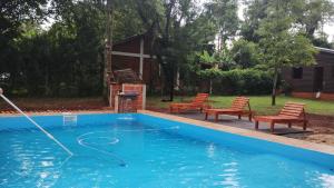 una piscina con una manguera en un patio en Los Pioneros en Puerto Iguazú
