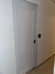 a door in a room with a white wall at 176 Calle Perez 2A1 in San Juan