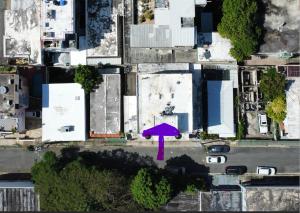 a purple umbrella in the middle of a city at 176 Calle Perez 2A1 in San Juan