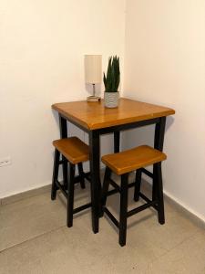 a table with two chairs and a lamp and a plant at 176 Calle Perez 2A1 in San Juan