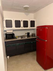 a kitchen with a red refrigerator and a microwave at 176 Calle Perez 2A1 in San Juan