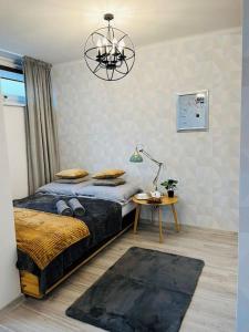 a bedroom with a bed and a chandelier at Apartament z panoramicznym widokiem w Centrum in Warsaw