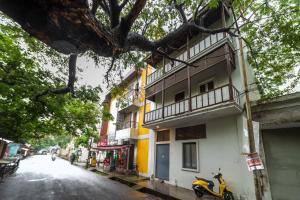 a scooter parked next to a building on a street at FTP (French Town Palacial) in Puducherry