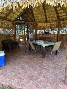 a patio with a table and chairs in a pavilion at Finca Campestre Los Pinos in Arteaga