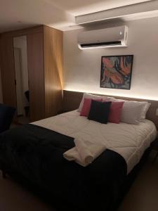ein Schlafzimmer mit einem großen Bett mit Kissen darauf in der Unterkunft Apartamento Praia Flamengo Charme in Rio de Janeiro