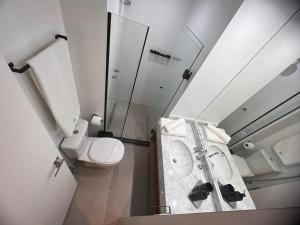 a small bathroom with a toilet and a shower at Apartamento Praia Flamengo Charme in Rio de Janeiro +13 photos