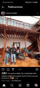 two men standing in a room with a motorcycle at Casona la Vega in Pasto