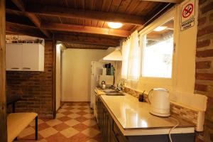 a kitchen with a counter and a sink and a window at Cabaña Robertino in El Bolsón
