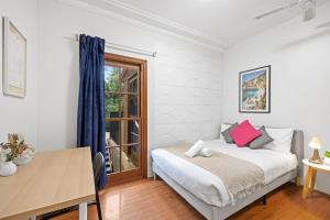 a bedroom with a bed and a desk and a window at Private Room in Gordon near Train & Bus - Sleeps 1 in Pymble