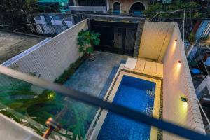 - une vue sur la piscine dans une maison dans l'établissement Sunset Pool Villa 4BR, New, Full AC, walk to beach, à Đà Nẵng
