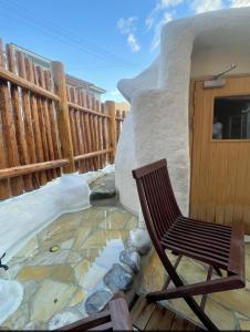 a chair sitting on a patio next to a fence at 源泉かけ流し温泉＆プライベートサウナ付き一棟貸しVilla SOUQ Echigo-yuzawa Hanare in Yuzawa