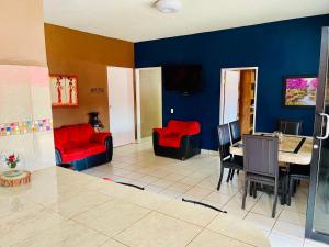 a living room with red couches and a table at Casa El Pescador in Mulegé