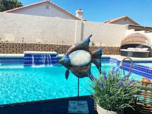 a statue of a peacock standing next to a swimming pool at J’s amazing pool and hot Jaccuzi sweet house in Las Vegas