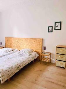 a bedroom with a large bed and a night stand at Gite Des Lacs Jumeaux in Clairvaux-les-Lacs