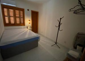 um quarto com uma cama num quarto com uma janela em Aconchego da praia em Capão da Canoa