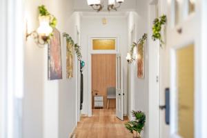 a hallway of a home with white walls and wooden floors at Premier Leichhardt Stayz in Sydney