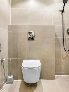 a bathroom with a white toilet and a shower at GR - A quiet bedroom apartment 10 in Riyadh