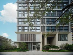 a tall white building with a lot of windows at East Maple Hotel Apartment - Guangzhou Financial City Sanxi Metro Station in Guangzhou