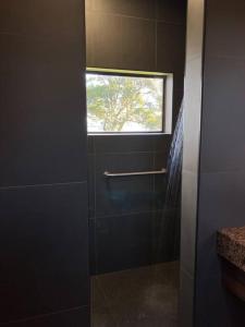 a bathroom with a window and a walk in shower at Faraway on Flinders Island 