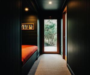 a dark room with a bed and a window at Faraway on Flinders Island 