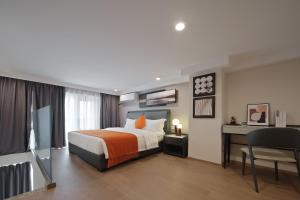 Ένα ή περισσότερα κρεβάτια σε δωμάτιο στο East Maple Hotel Apartment - Guangzhou Financial City Sanxi Metro Station