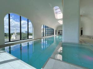 a swimming pool in a building with windows at 1 BRM 1 Study 1 BATH, Southern Cross Station, Flagstaff Garden in Melbourne