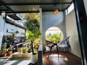 a patio with a swing and a chair on a porch at Gió Homestay - Pleiku in Pleiku