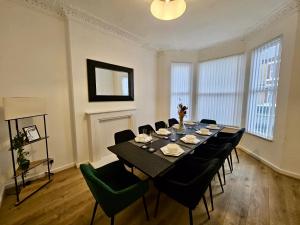 a large dining room with a table and chairs at Large NEW House, Sleeps 10, FREE Parking, Near City Centre in Liverpool